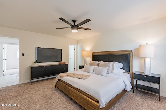 bedroom with ceiling fan and light carpet