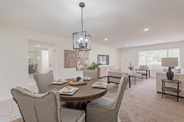 tiled dining space with an inviting chandelier