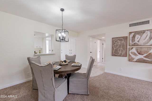 carpeted dining room with a notable chandelier