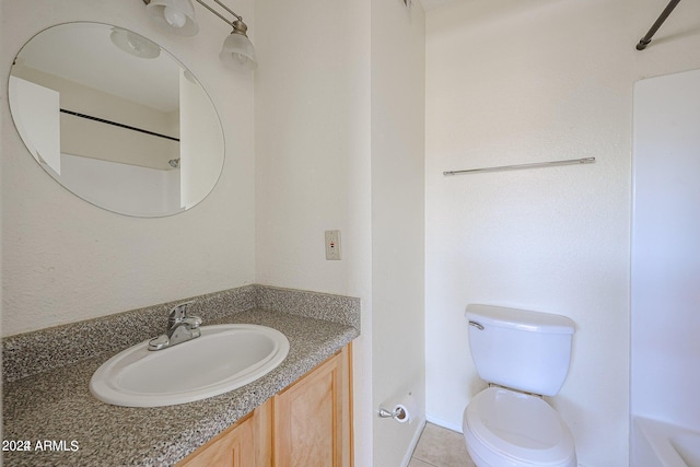 bathroom featuring toilet, tile patterned flooring, and vanity