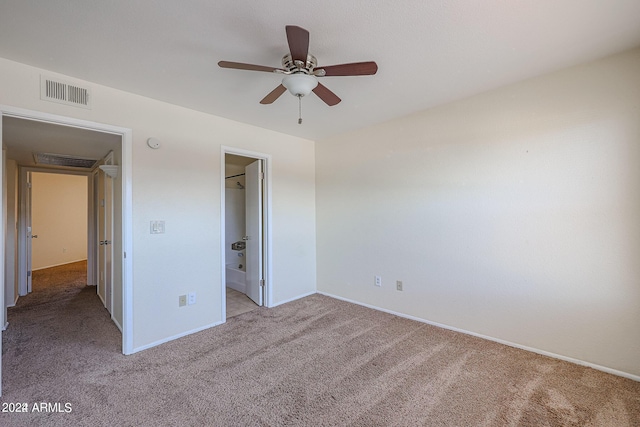 unfurnished bedroom featuring connected bathroom, ceiling fan, and light colored carpet