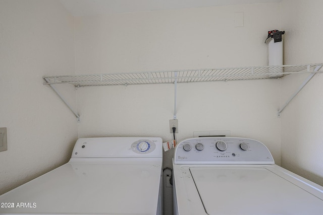 clothes washing area featuring washer and clothes dryer