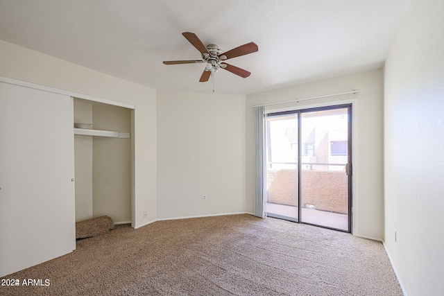 unfurnished bedroom featuring ceiling fan, access to exterior, a closet, and carpet floors