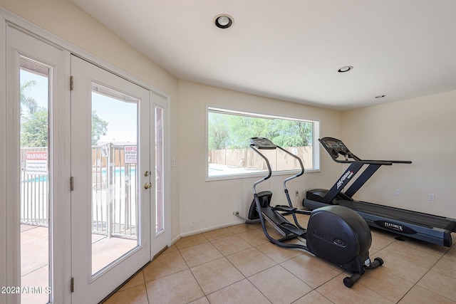 exercise area with light tile patterned floors and plenty of natural light