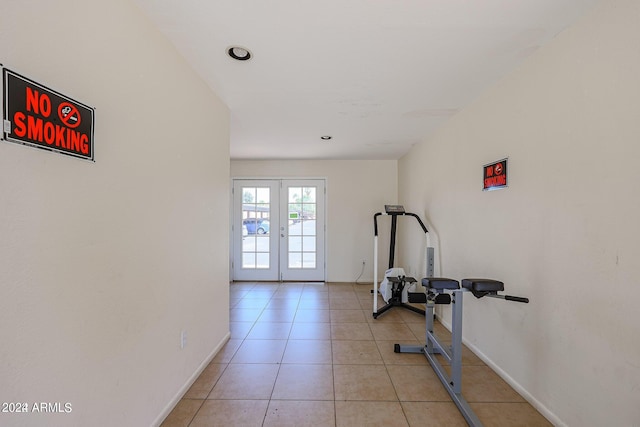 workout area with light tile patterned floors and french doors