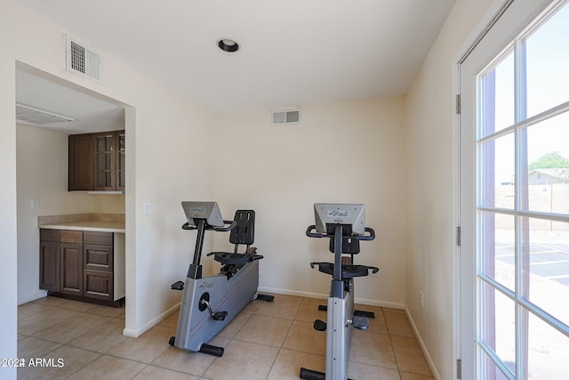 exercise room featuring light tile patterned flooring