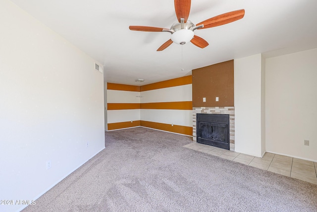 unfurnished living room with light carpet, ceiling fan, and a fireplace