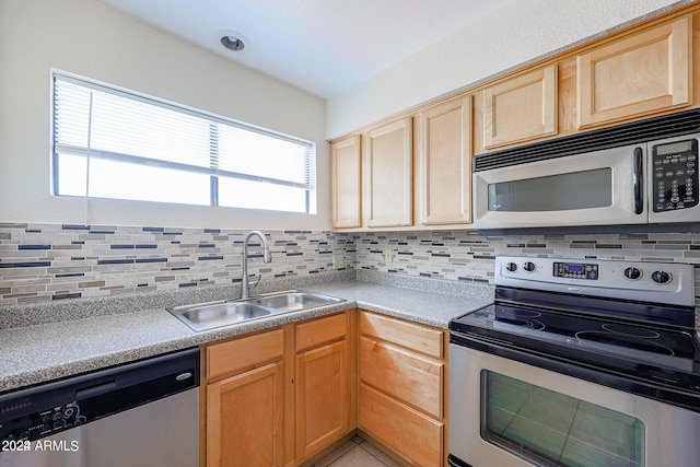 kitchen featuring light tile patterned floors, stainless steel appliances, light brown cabinets, backsplash, and sink