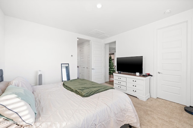 bedroom featuring light carpet