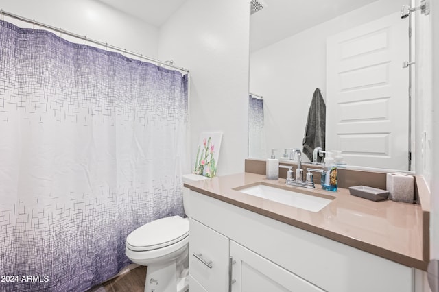 bathroom with hardwood / wood-style floors, vanity, and toilet