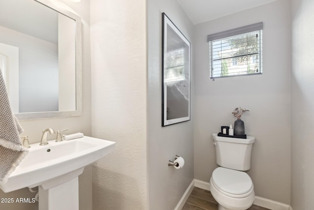 1941 W Yellowstone Way, Chandler, AZ 85248 - half bathroom featuring toilet, baseboards, wood finished floors, and a sink