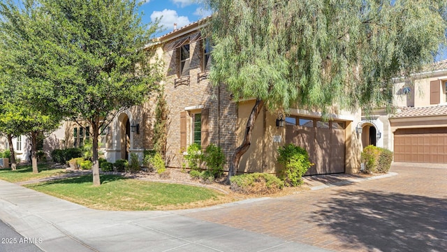 1941 W Yellowstone Way, Chandler, AZ 85248 - view of front of house featuring decorative driveway, stucco siding, a tile roof, and a front yard
