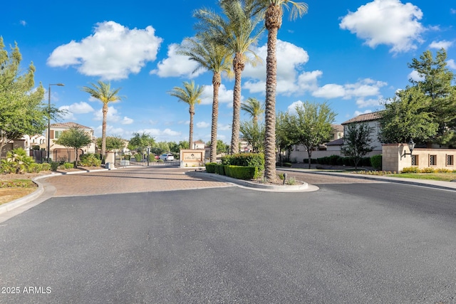 1941 W Yellowstone Way, Chandler, AZ 85248 - view of asphalt road featuring a residential view, curbs, a gate, and street lights