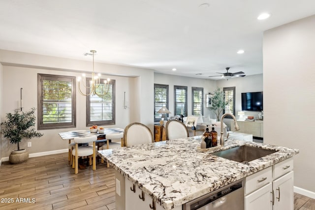 1941 W Yellowstone Way, Chandler, AZ 85248 - kitchen with a sink, stainless steel dishwasher, a chandelier, baseboards, and light wood-style flooring