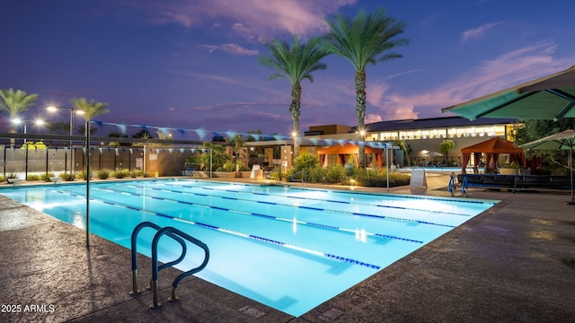 1941 W Yellowstone Way, Chandler, AZ 85248 - pool at dusk featuring a community pool and a patio