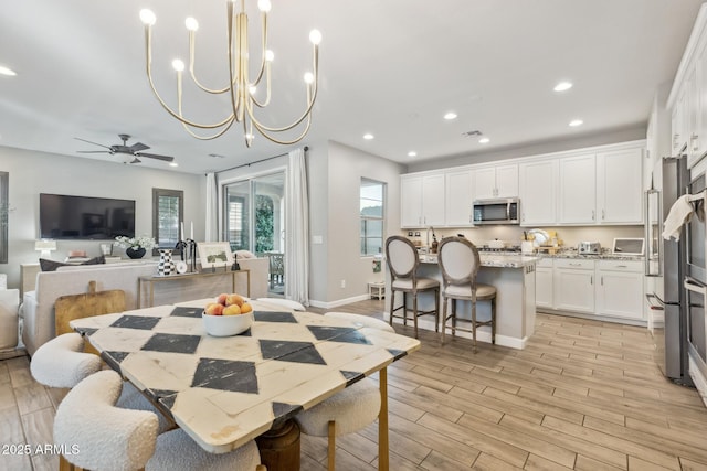 1941 W Yellowstone Way, Chandler, AZ 85248 - dining space featuring recessed lighting, a ceiling fan, light wood finished floors, a chandelier, and baseboards