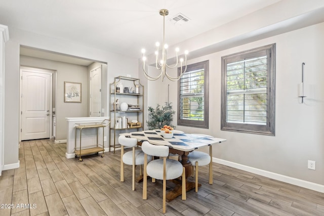 1941 W Yellowstone Way, Chandler, AZ 85248 - dining room featuring a chandelier, light wood-type flooring, and baseboards
