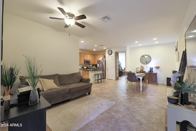 tiled living room with ceiling fan