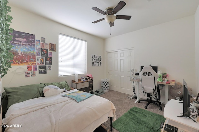 carpeted bedroom featuring ceiling fan and a closet