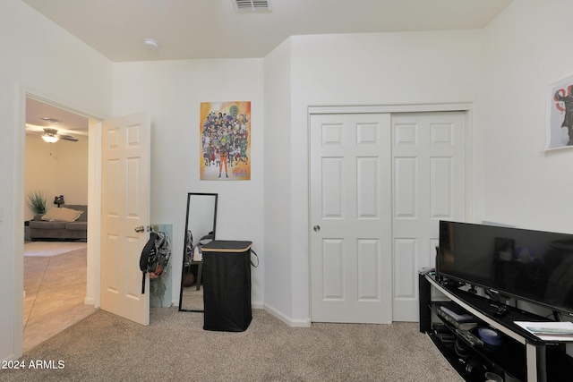 interior space with light colored carpet and ceiling fan