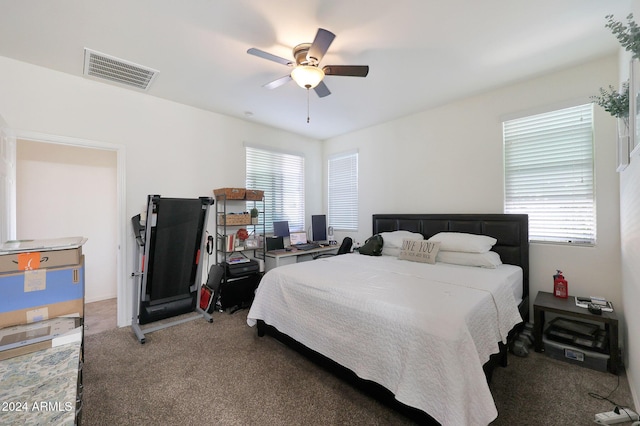 bedroom featuring multiple windows, ceiling fan, and carpet floors