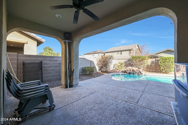 view of patio with a fenced in pool and ceiling fan