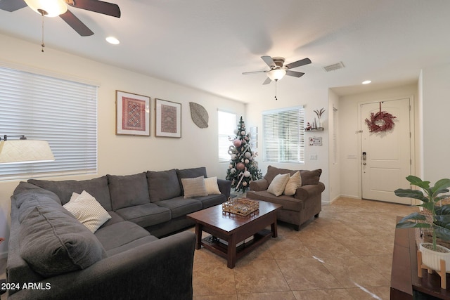 living room featuring light tile patterned flooring and ceiling fan