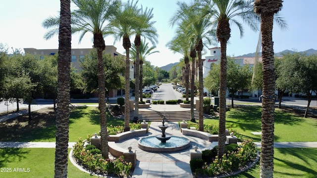 view of home's community with a yard and a mountain view