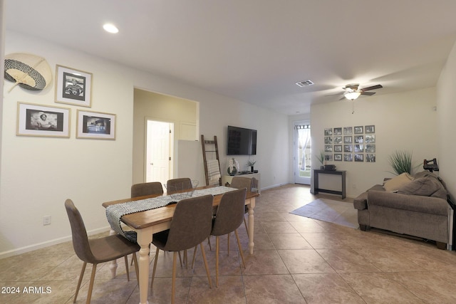 tiled dining area with ceiling fan