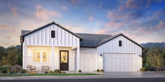 modern farmhouse style home featuring driveway, board and batten siding, roof with shingles, an attached garage, and brick siding