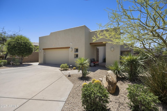 14007 E Lupine Ave, Scottsdale, AZ 85259 - pueblo revival-style home featuring stucco siding, a garage, and driveway