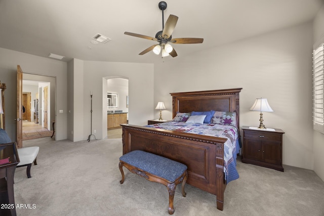 14007 E Lupine Ave, Scottsdale, AZ 85259 - bedroom featuring light colored carpet, arched walkways, ensuite bath, and a ceiling fan