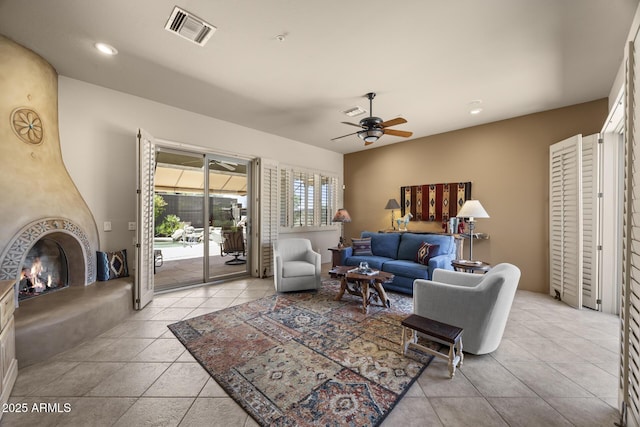 14007 E Lupine Ave, Scottsdale, AZ 85259 - living room with ceiling fan, light tile patterned flooring, a lit fireplace, and recessed lighting