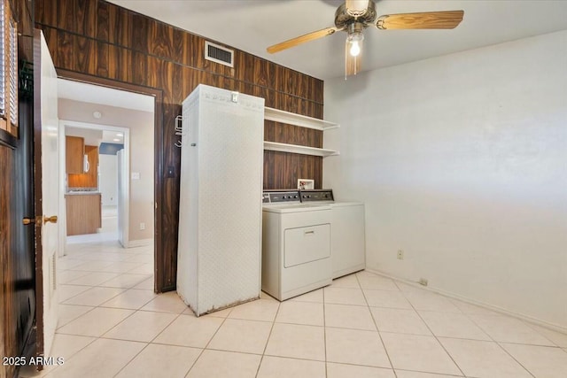 clothes washing area with light tile patterned floors, ceiling fan, laundry area, visible vents, and washing machine and clothes dryer