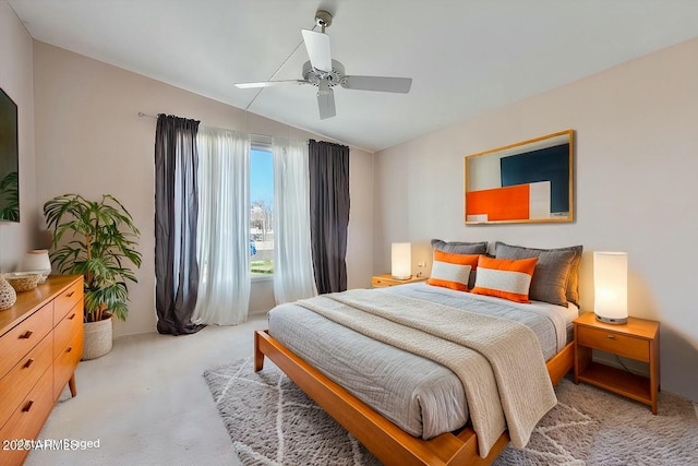 bedroom featuring a ceiling fan, lofted ceiling, and light carpet