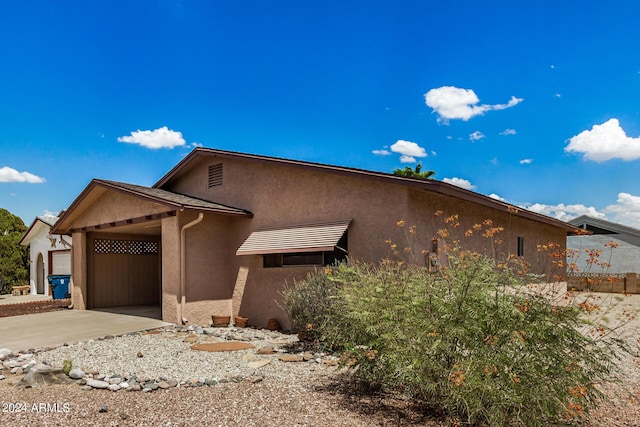 view of front of home with concrete driveway and stucco siding