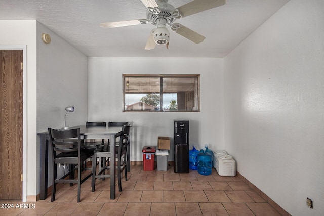 tiled dining room featuring a ceiling fan