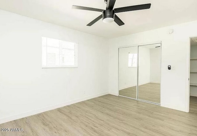 4450 N Longview Ave, Phoenix, AZ 85014 - unfurnished bedroom with light wood-type flooring, a closet, a ceiling fan, and baseboards