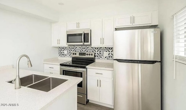 4450 N Longview Ave, Phoenix, AZ 85014 - kitchen with appliances with stainless steel finishes, a sink, and white cabinetry
