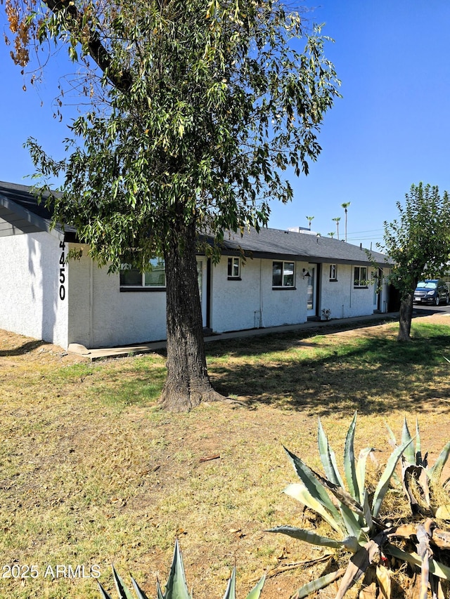 4450 N Longview Ave, Phoenix, AZ 85014 - back of house featuring stucco siding and a lawn