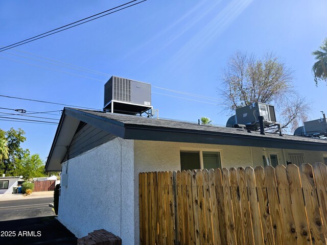 4450 N Longview Ave, Phoenix, AZ 85014 - view of home's exterior featuring cooling unit, fence, and stucco siding
