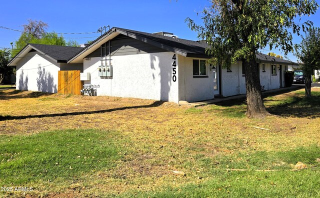4450 N Longview Ave, Phoenix, AZ 85014 - view of front of house with a front yard and stucco siding
