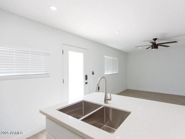 4450 N Longview Ave, Phoenix, AZ 85014 - kitchen featuring a sink, light countertops, ceiling fan, light wood-style flooring, and recessed lighting