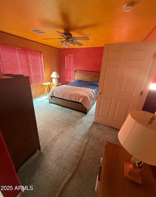 bedroom featuring carpet flooring, visible vents, and a ceiling fan