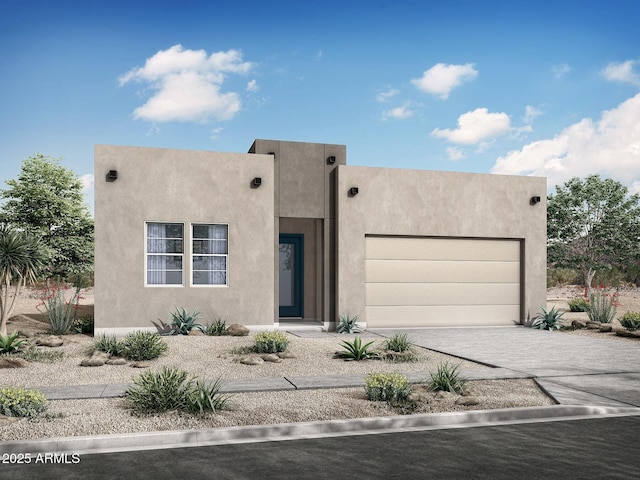 pueblo-style home with stucco siding, an attached garage, and driveway