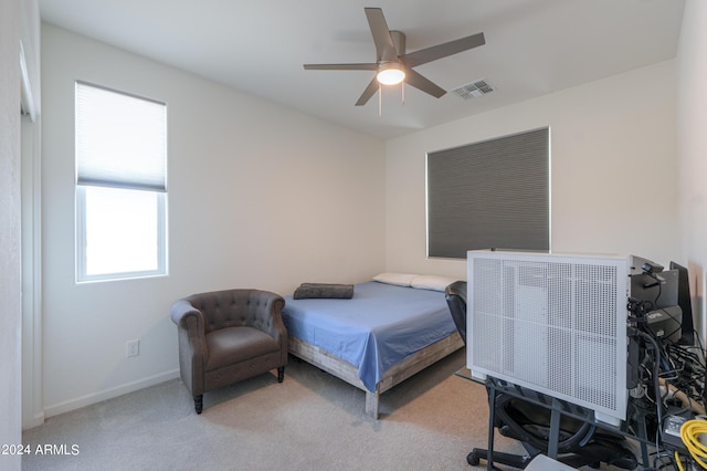 bedroom with carpet flooring, visible vents, and ceiling fan