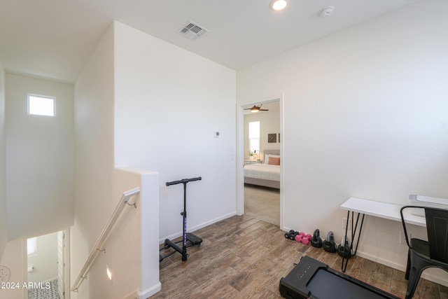 exercise room with visible vents, baseboards, and wood finished floors