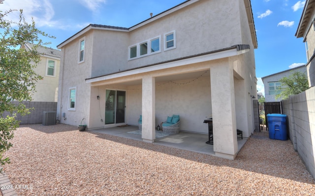 back of property with cooling unit, stucco siding, a patio, and a fenced backyard