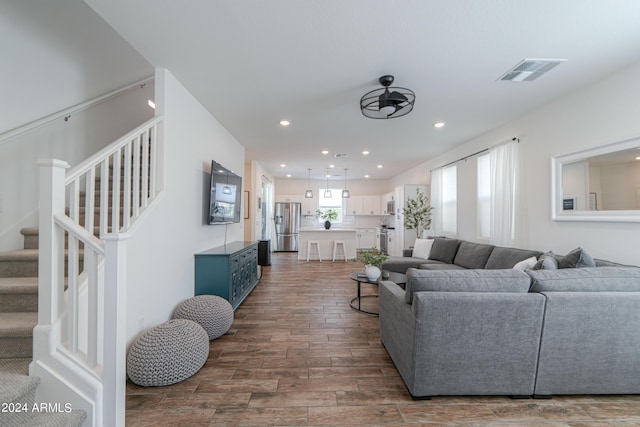 living room featuring visible vents, recessed lighting, stairway, and dark wood-style flooring