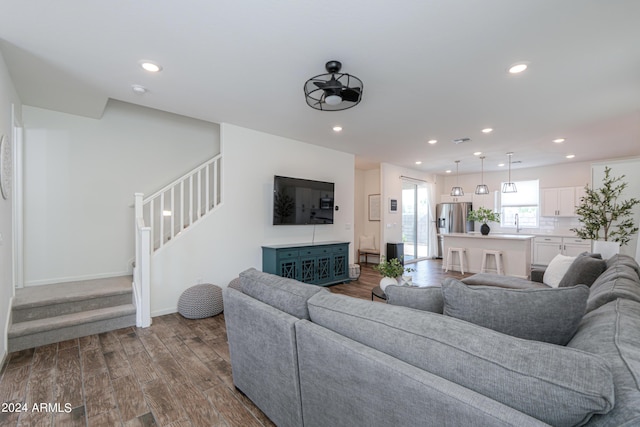 living area with stairway, dark wood-style floors, visible vents, baseboards, and recessed lighting